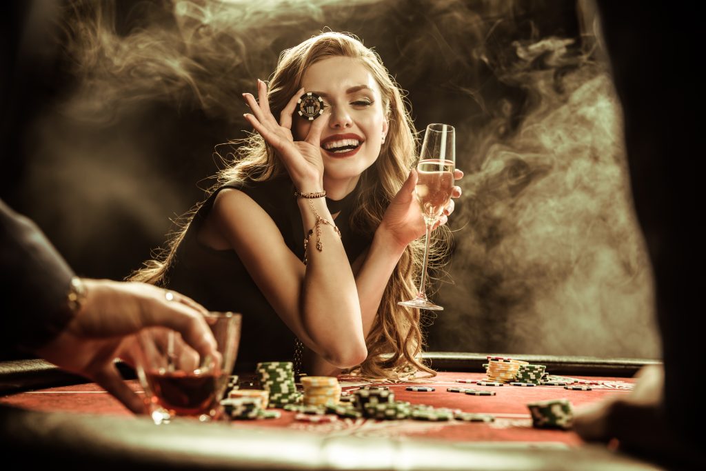 portrait of smiling woman with drink and poker chi LFNFV4U